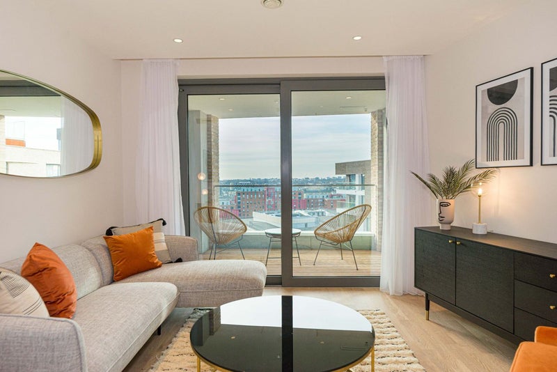 Photo 1: Living room and balcony overlooking canal