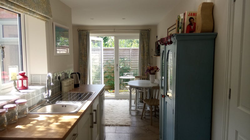 Photo 1: Kitchen/dining area with small patio beyond