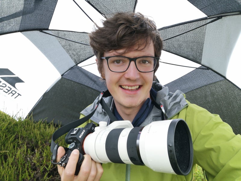 Photo 1: Looking pleased with umbrella purchase
