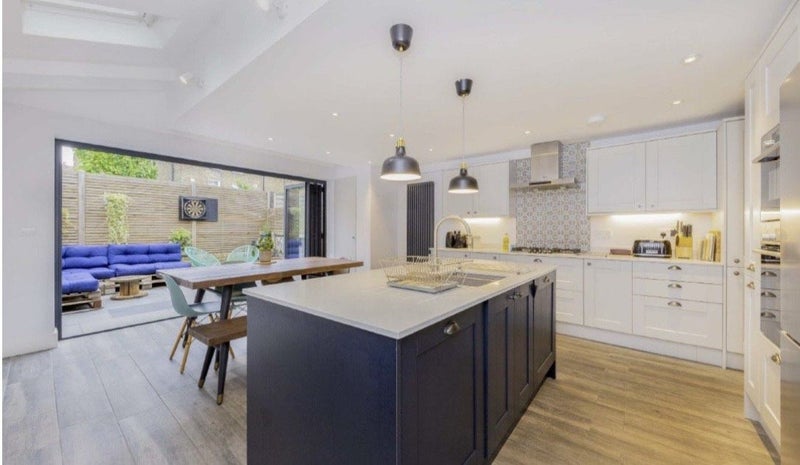 Photo 1: Kitchen with bi folds to garden