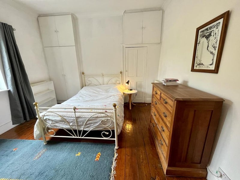 Photo 1: Spacious Bedroom with Accompanying Furniture