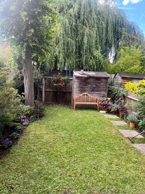 Photo 1: Large sunny garden with seating area and patio 