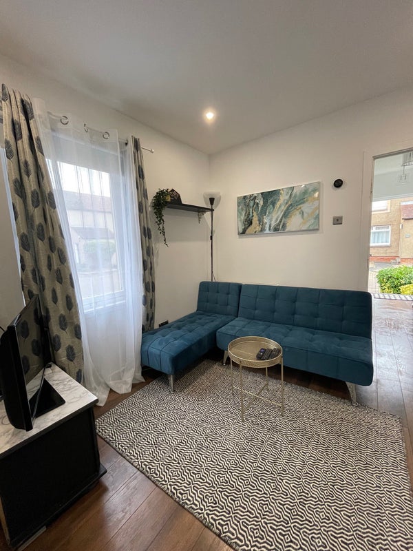 Photo 1: Shared living space with TV