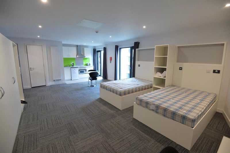 Photo 1: Twudio with two small double beds.