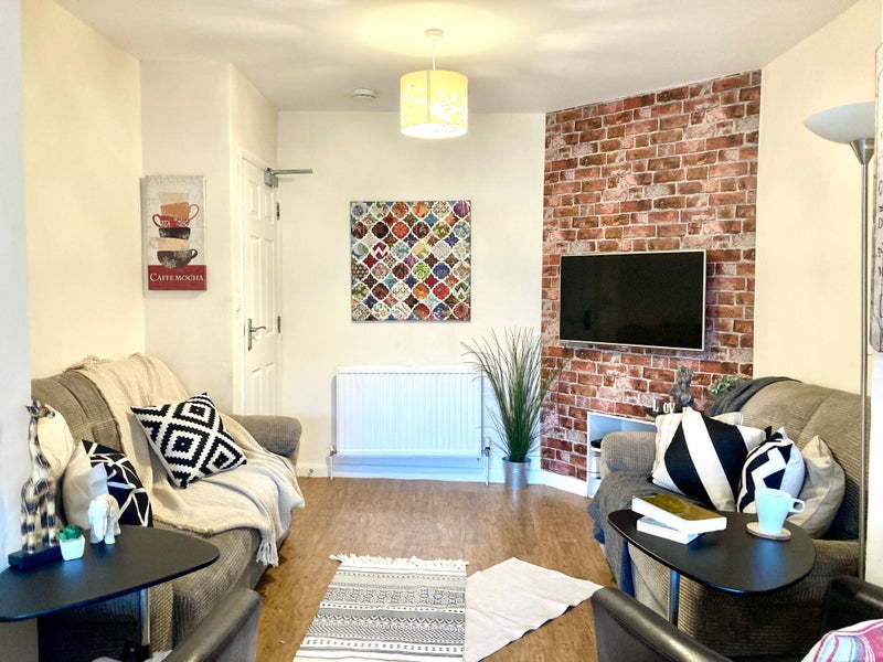 Photo 1: Comfortable living room to relax after a hard days work