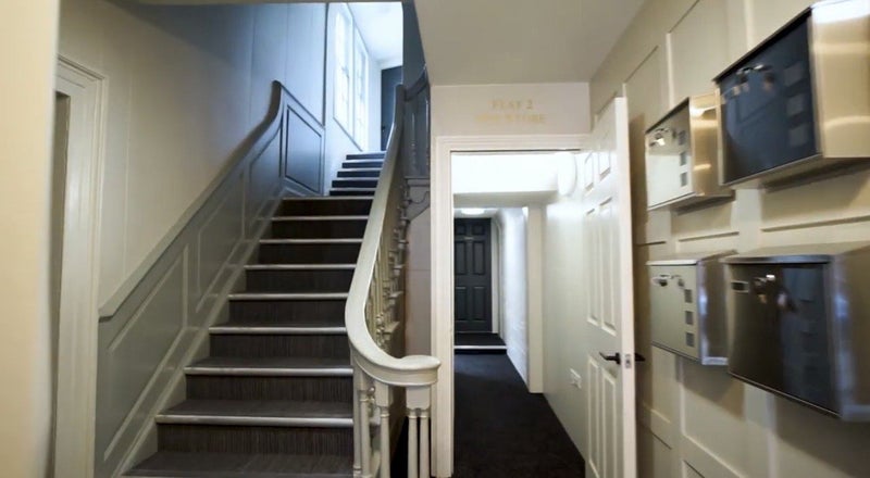 Photo 1: Stairs leading to first floor where flat is 