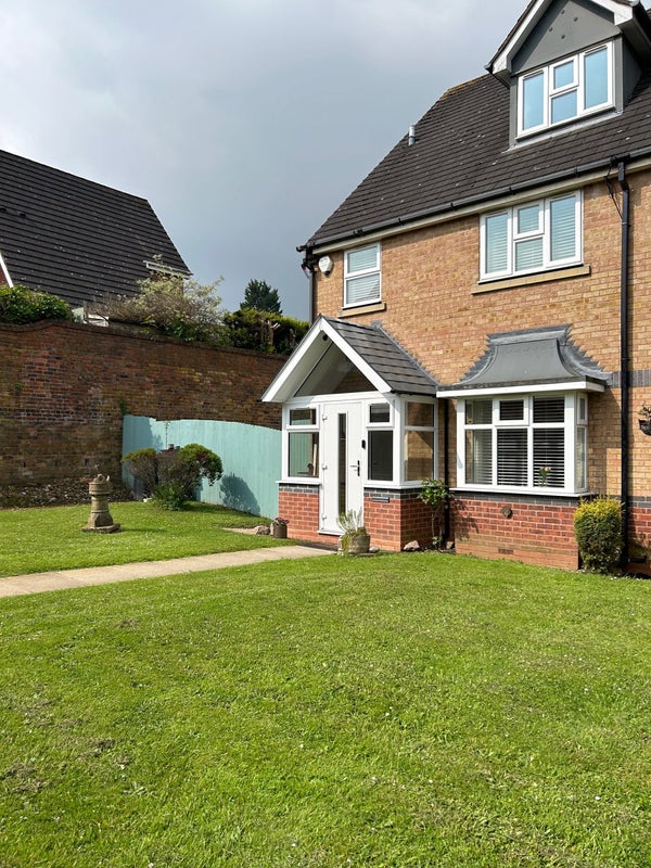 Photo 1: Front view of house with shared driveway 