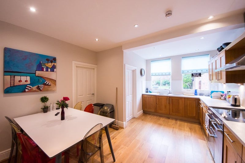 Photo 1: Communal kitchen/dining area