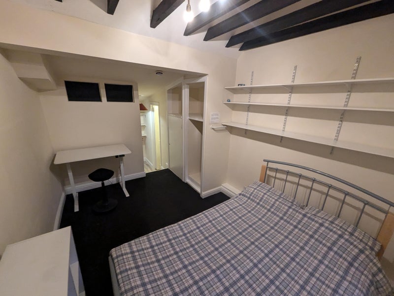 Photo 1: There is a double bed with storage above, adjustable height desk 
