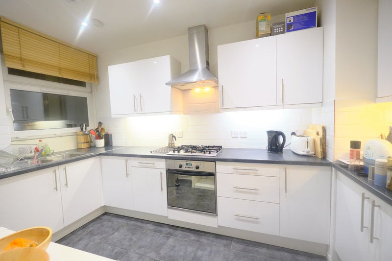 Photo 1: Kitchen with gas cooker and electric oven