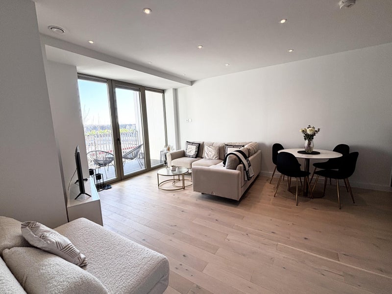 Photo 1: Living area leading to balcony