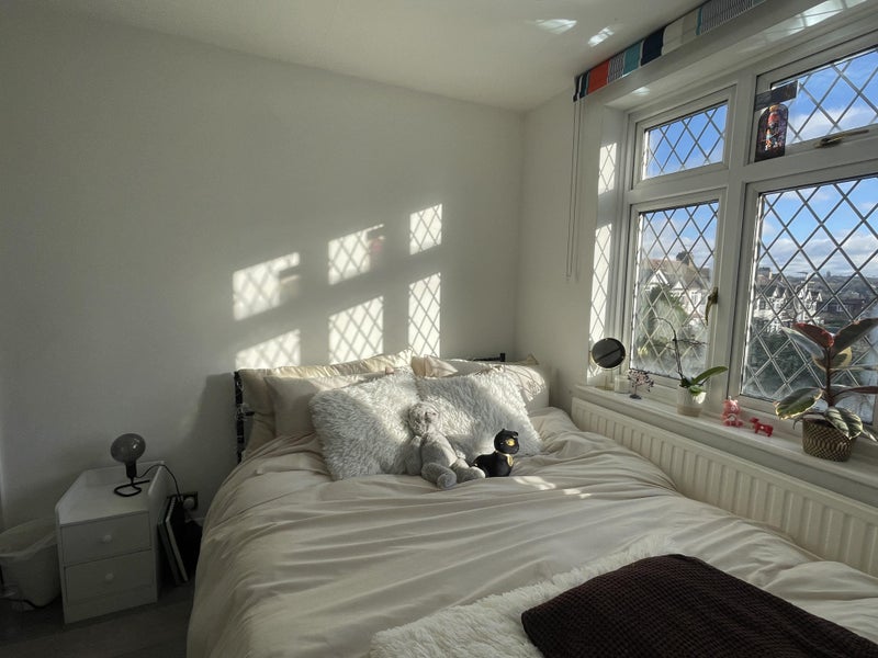 Photo 1: The room features large windows that let in plenty of natural light.