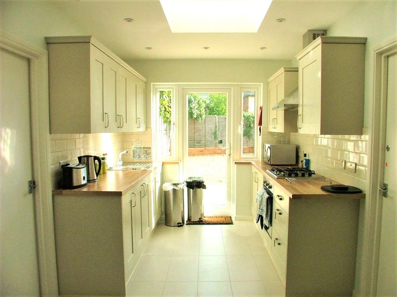 Photo 1: Sunny kitchen opens onto garden