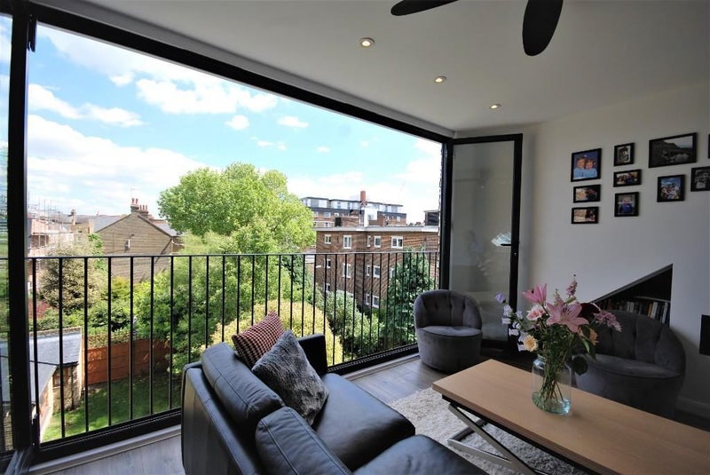 Photo 1: Living room with floor to ceiling bifold windows