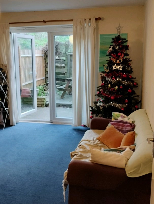 Photo 1: Living room looking out on to private patio