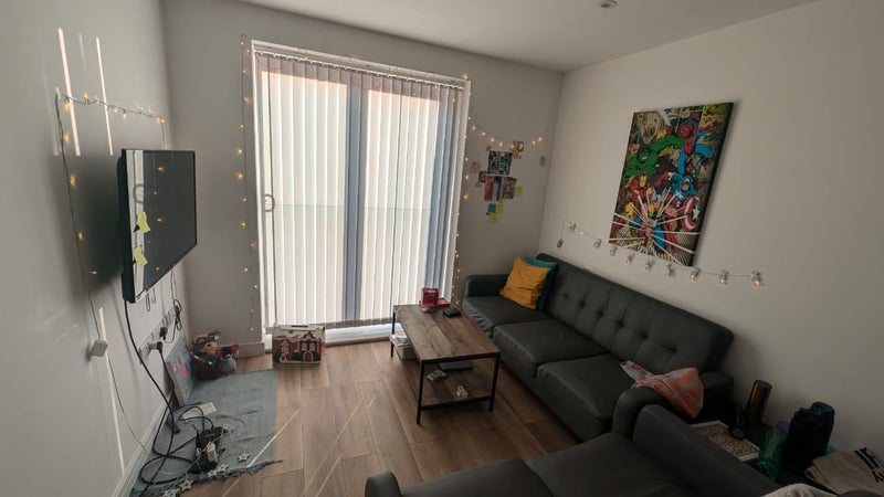 Photo 1: Living room/common area with dining table and TV