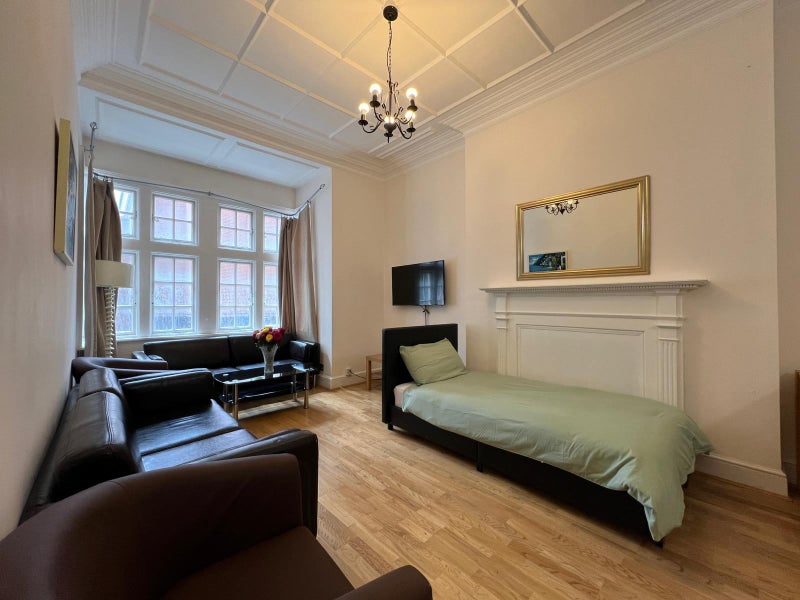 Photo 1: Living room with extra bed