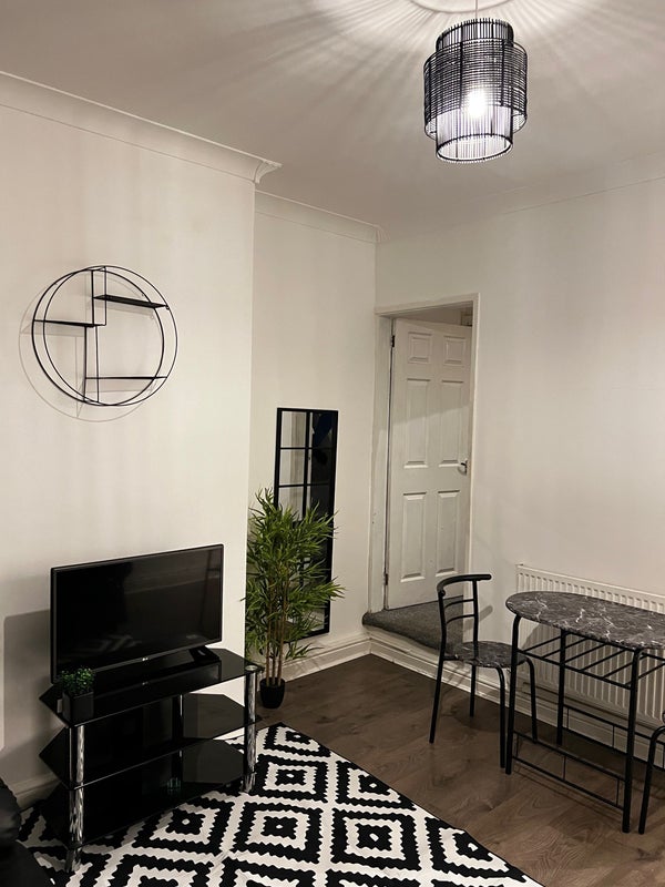 Photo 1: Living room with tv 