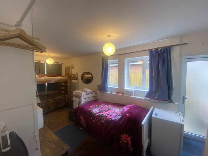 Photo 1: The bed with  red theiw has gine and been replsced with a wirk top / hob/ sink and fridge  