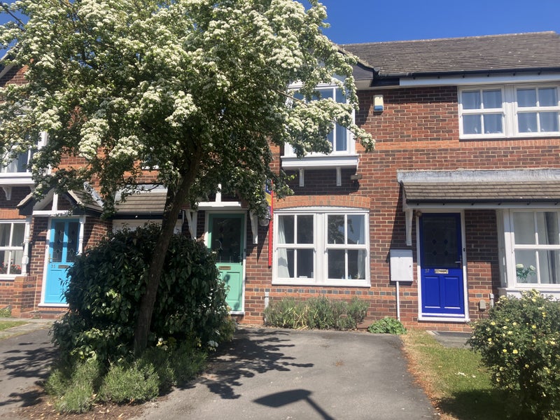 Photo 1: Front elevation with parking space