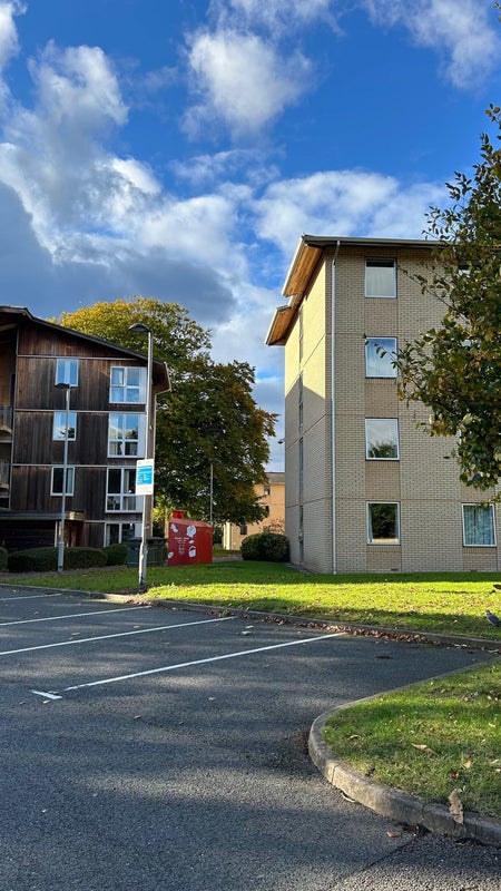 Photo 1: Outside view of Elgar Court – quiet, green, and safe environment.