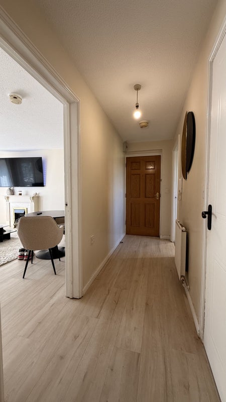 Photo 1: Bright, airy hallway with wood-style flooring – a welcoming entrance to your new home.