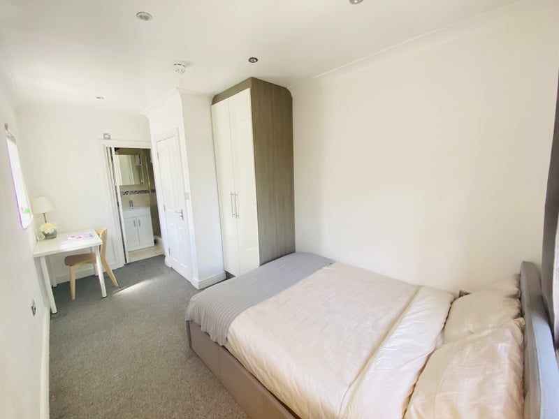 Photo 1: One side of the room showcasing double bed and wardrobe 