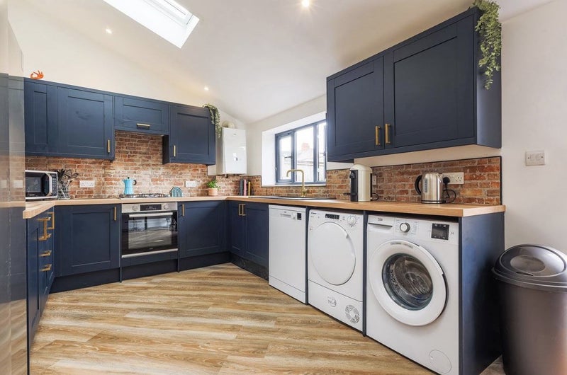 Photo 1: Kitchen dining area with dishwasher, tumble dryer and washing machine