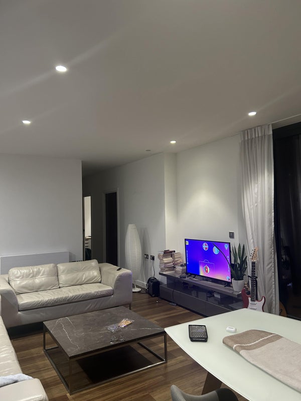 Photo 1: Shared Living Room with TV