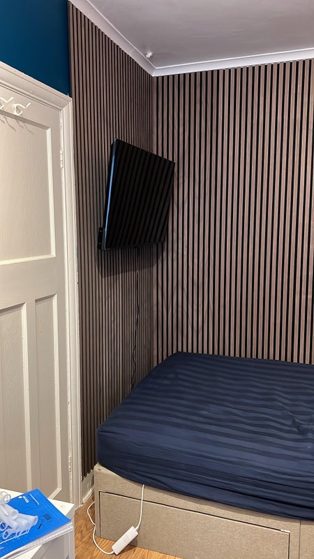 Photo 1: Tv on wall with panels 