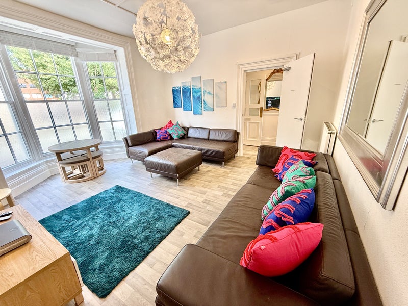 Photo 1: Large lounfe with 60” tv 