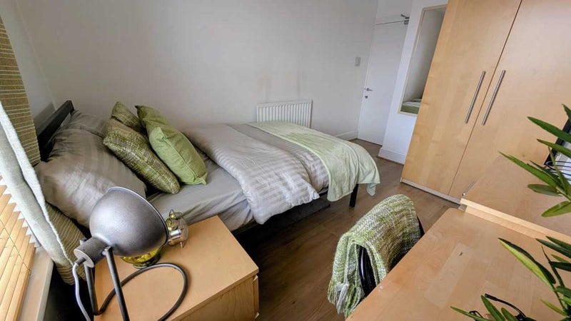 Photo 1: Bedroom with double bed, high ceiling and plenty of storage overlooking garden