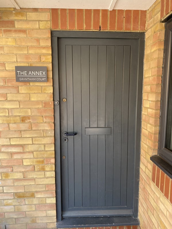 Photo 1: Entrance door to side of main house 
