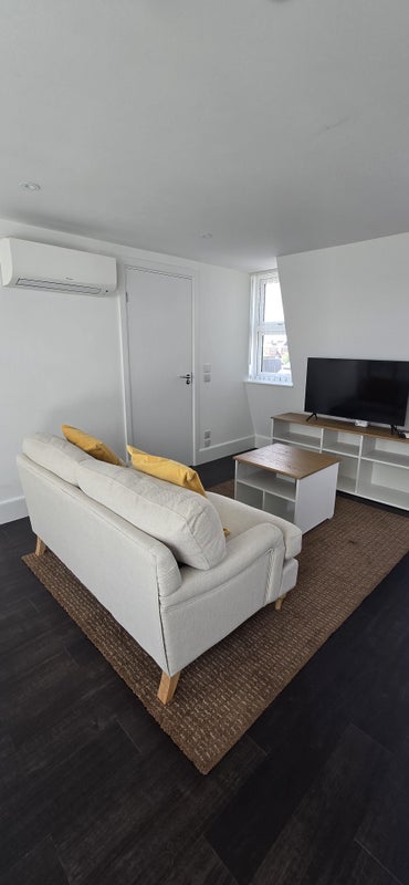 Photo 1: Lounge area and door to shower room