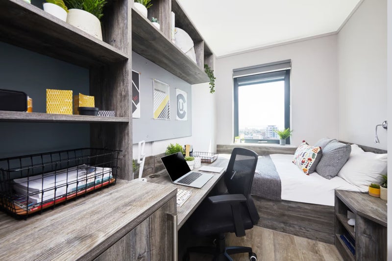 Photo 1: Desk and bed