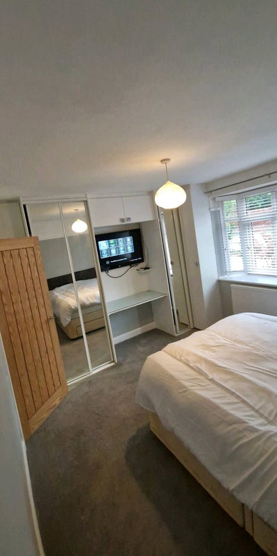 Photo 1: bedroom: completely redecorated. mirrored built in wardrobe and desk with lots of storage and tv