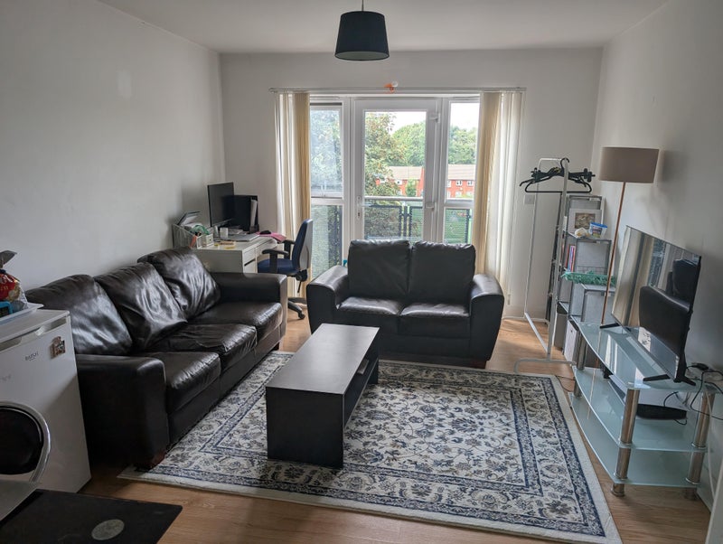 Photo 1: Living area and balcony