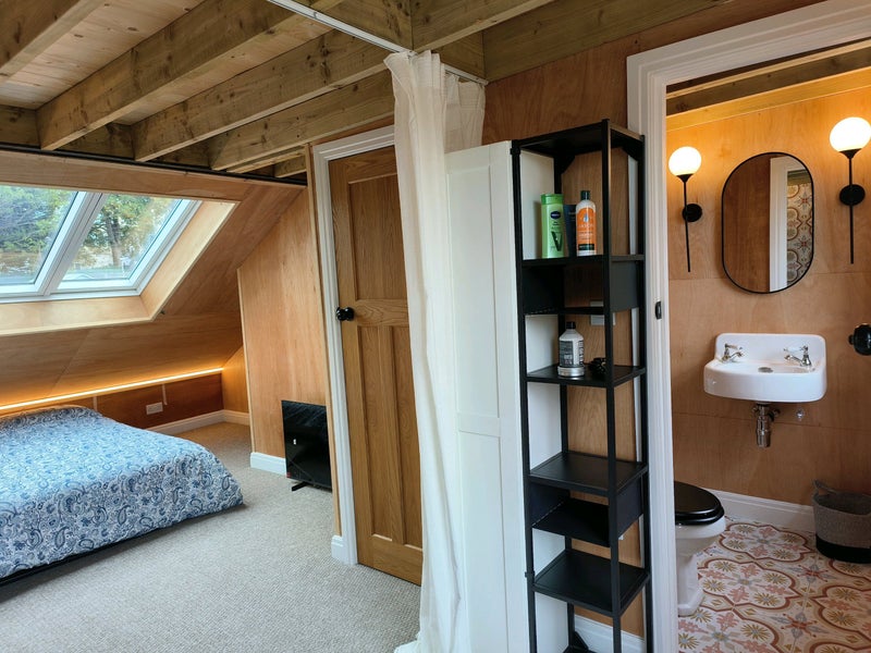 Photo 1: Room 1 - View towards triple skylights and basin with toilet, under eaves storage coming Aug 25th