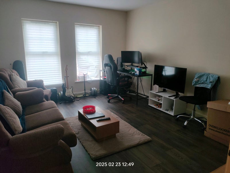 Photo 1: Living Room equipped with couches and a TV