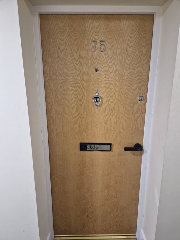 Photo 1: Front door of apartment