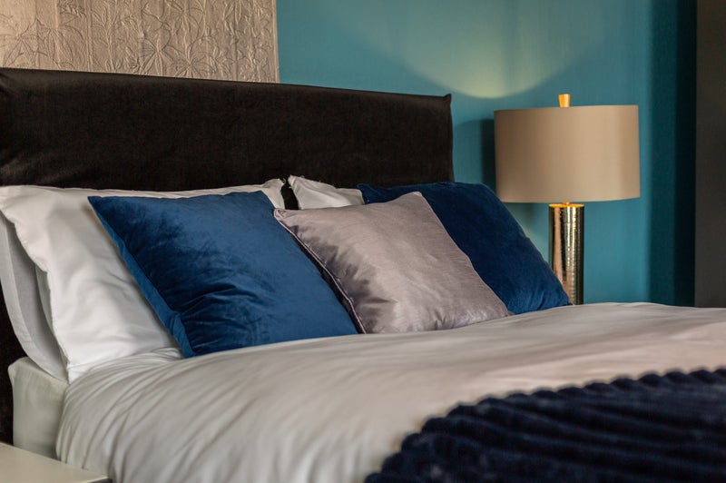 Photo 1: Plush bedding & cosy lighting