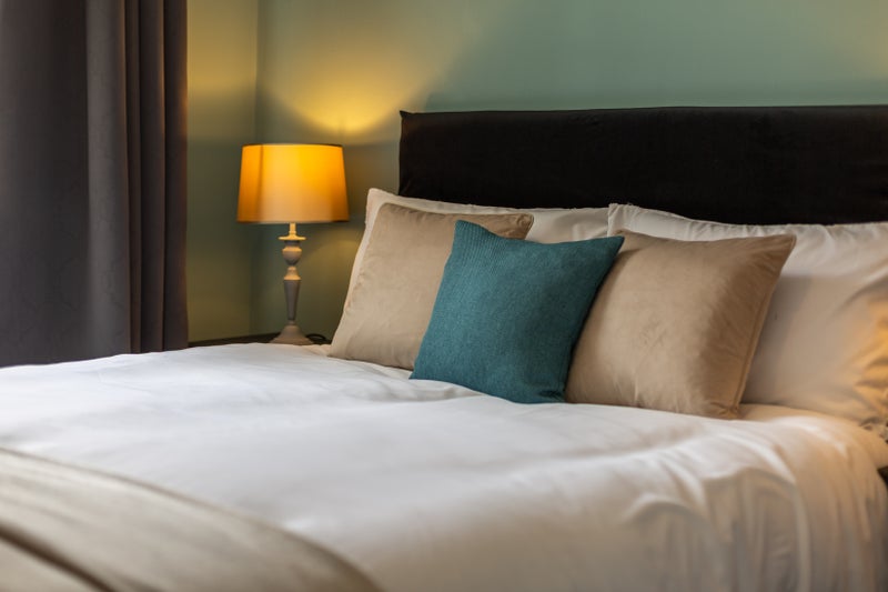 Photo 1: Fresh linens, hushed curtains wrap the day away.