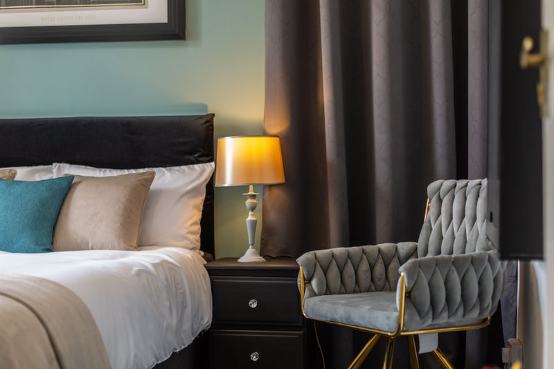 Photo 1: Claim your cosy corner plush chair, warm lamp, deep calm.