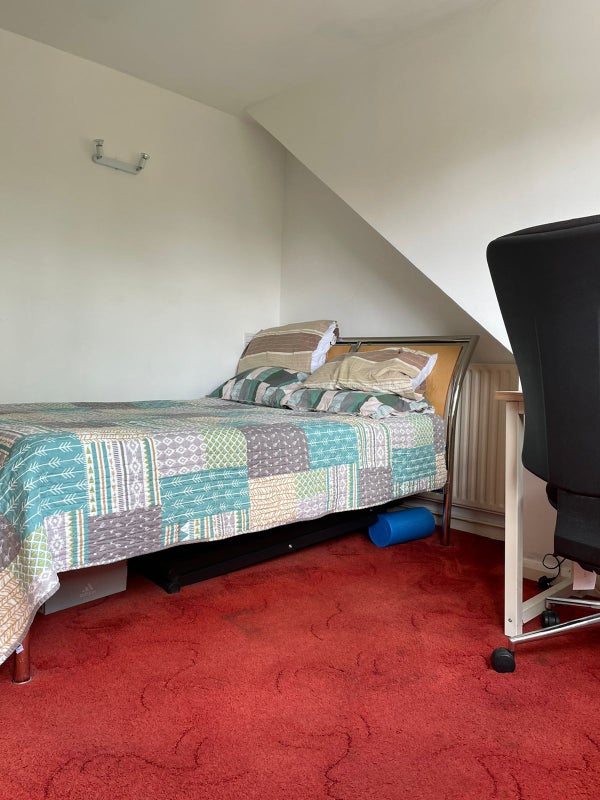 Photo 1: Double bed with radiator in bedroom