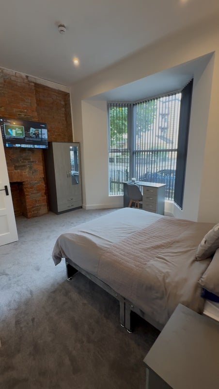 Photo 1: Spacious double bed, furniture and TV.