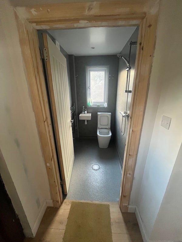 Photo 1: Downstairs bathroom which is a wet room with a power shower