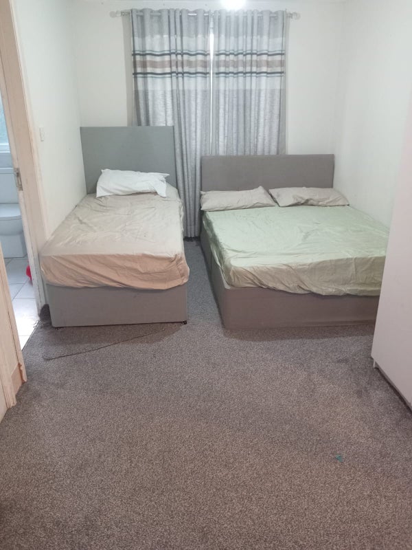 Photo 1: Double bed and a single bed, with the glimpse of the en-suite bathroom.