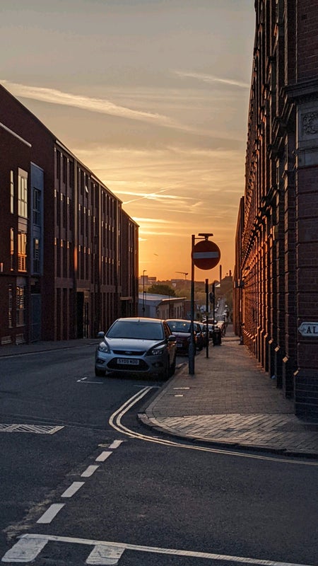 Photo 1: View from the street at sunset