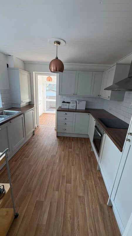 Photo 1: Kitchen with fridge and washing machine