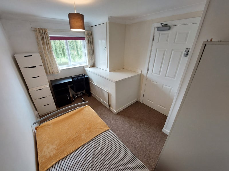 Photo 1: Single bedroom over looking green 